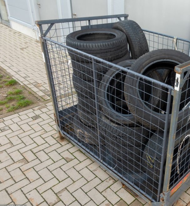 Many old tyres pile up in front of a garage to be disposed of.